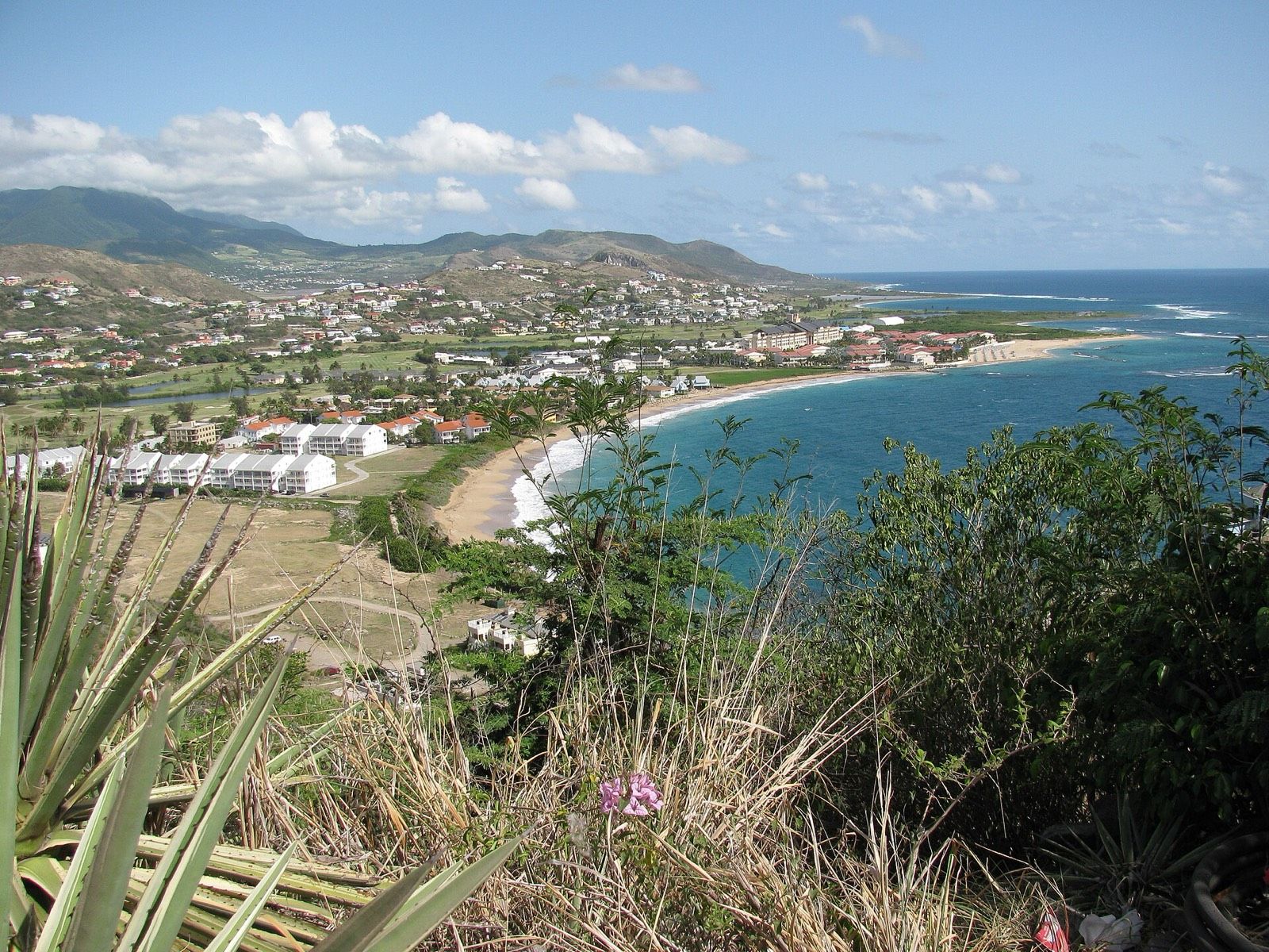 Frigate Bay seen from the hills, with the calm Caribbean side and the Atlantic beyond