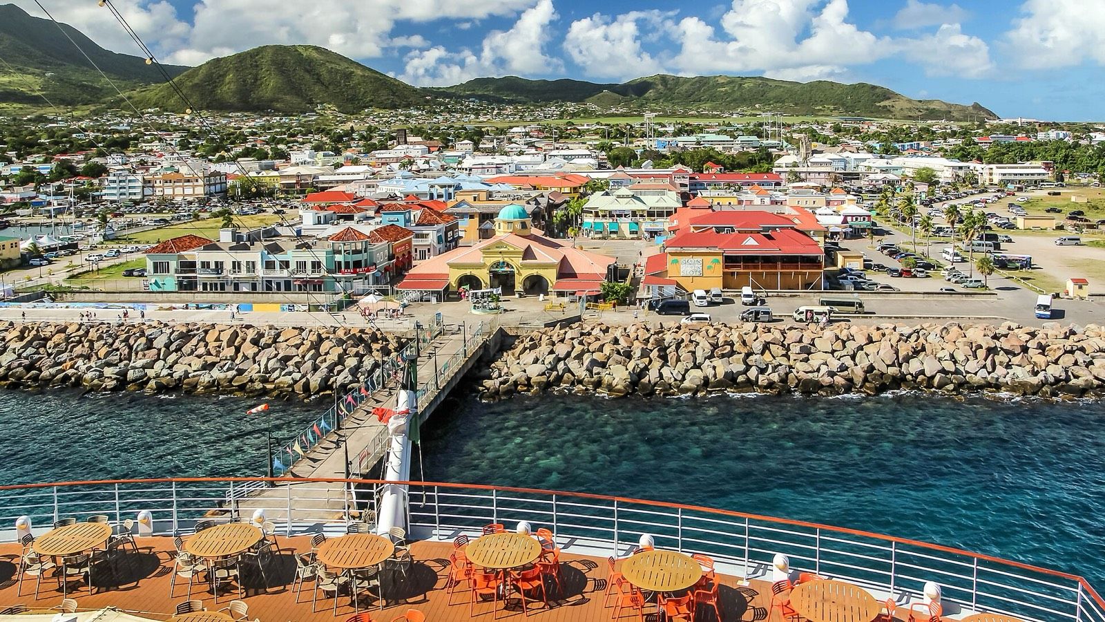 Port Zante and the Basseterre waterfront seen from the deck of a cruise ship, with green hills behind the town